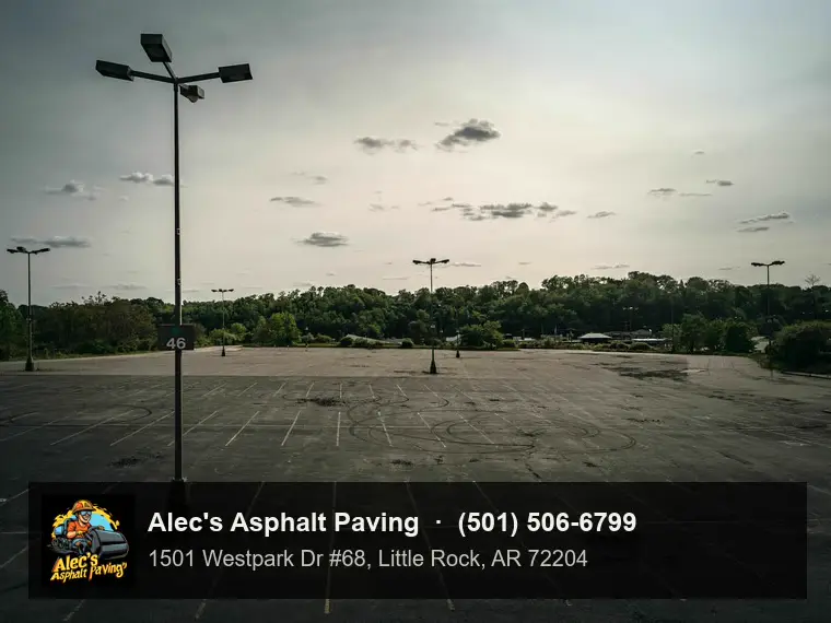 A large striped parking lot at dusk with tall light poles