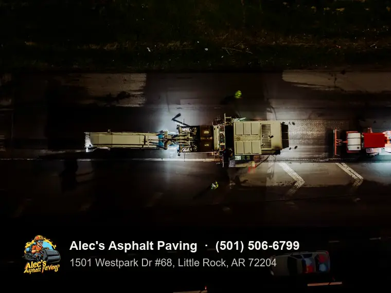 A paving crew working at night, seen from above